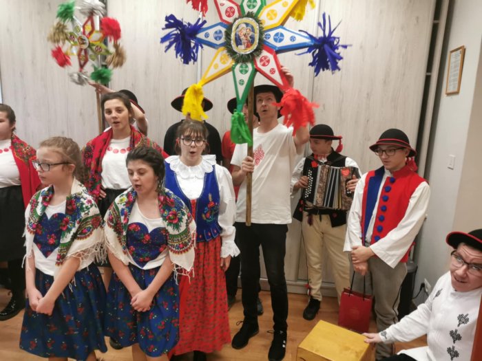 Uczniowie ubrani w stroje góralskie kolędują u Darczyńców szkoły.