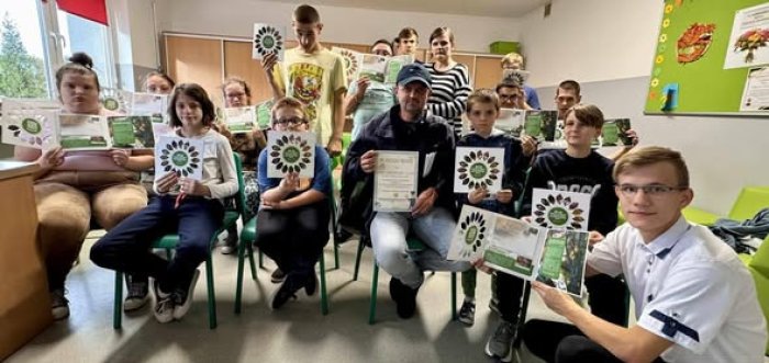 Wychowankowie internatu  pozują do zdjęcia z listonoszem.