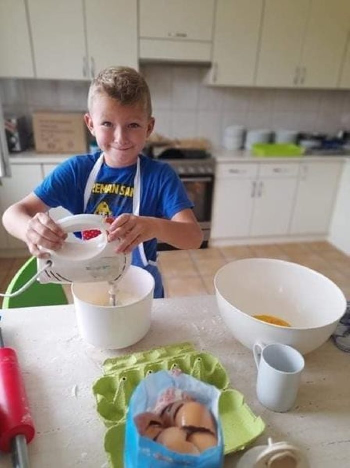 Uczeń korzysta z robota kuchennego. 